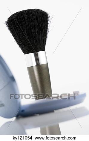 Picture - Eye-shadow box and make-up brush, close-up. Fotosearch