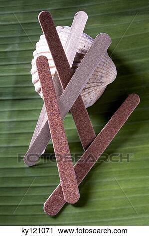 Stock Image - Nail files on a shell, close-up. Fotosearch