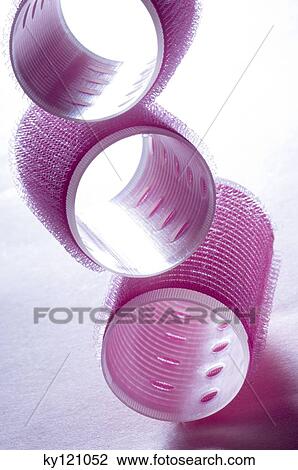 Stock Image - Pink hair curlers, close-up. Fotosearch