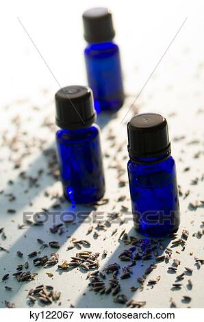 Stock Photo - 3 essential oil bottles, close-up. Fotosearch