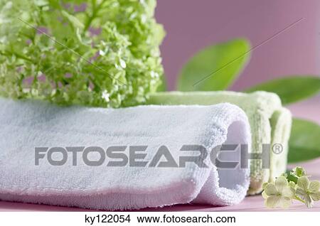 Bath towels and flowers, close-up View Large Photo Image Picture - Bath towels and flowers, close-up. Fotosearch