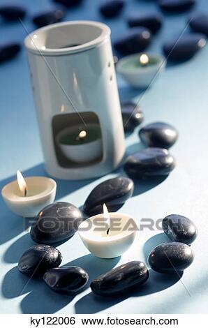 Candles, peebles and essential oil burner, close-up View Large Photo Image Stock Photograph - Candles, peebles and essential oil burner, close-up. Fotosearch