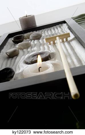 Candles, peebles and rake in zen garden, close-up View Large Photo Image Stock Image - Candles, peebles and rake in zen garden, close-up. Fotosearch