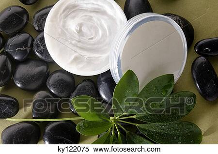 Stock Photography - Moisturizer and peebles, close-up. Fotosearch