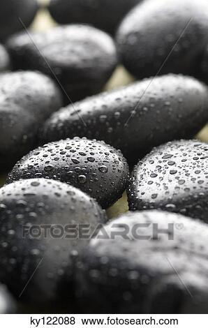 Stock Photo - Peebles and waterdrops, close-up. Fotosearch