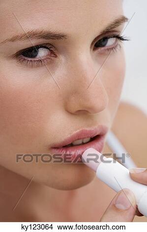 Portrait of a young woman holding white lilies View Large Photo Image Picture - Portrait of a young woman holding white lilies. Fotosearch