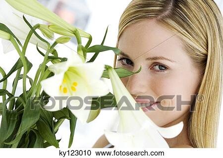 Portrait of a young woman holding white lilies View Large Photo Image Stock Image - Portrait of a young woman holding white lilies. Fotosearch