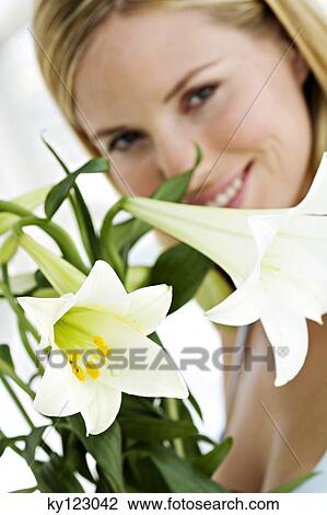 Portrait of a young woman holding white lilies View Large Photo Image Stock Image - Portrait of a young woman holding white lilies. Fotosearch