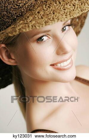 Portrait of a young woman looking at the camera, straw hat, indoors (studio) View Large Photo Image Stock Image - Portrait of a young woman looking at the camera, straw hat, indoors (studio). Fotosearch