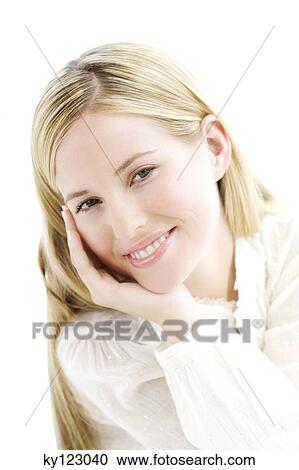Stock Image - Portrait of a young woman looking at the camera, indoors (studio). Fotosearch
