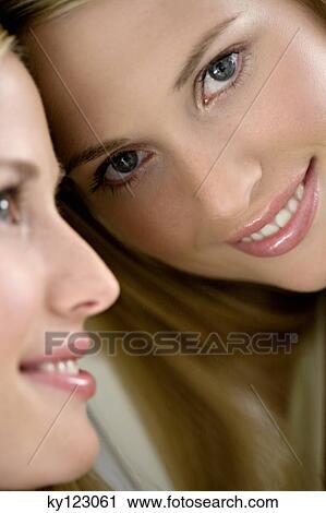 Portrait of a young woman looking at herself in a mirror View Large Photo Image Stock Image - Portrait of a young woman looking at herself in a mirror. Fotosearch