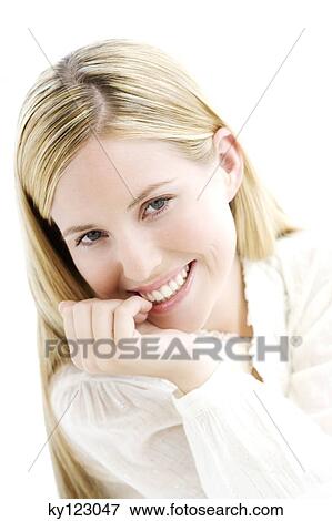 Stock Photo - Portrait of a young woman looking at the camera, indoors (studio). Fotosearch