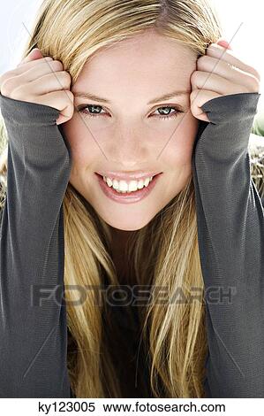 Portrait of a young woman looking at the camera, indoors (studio) View Large Photo Image Stock Photography - Portrait of a young woman looking at the camera, indoors (studio). Fotosearch