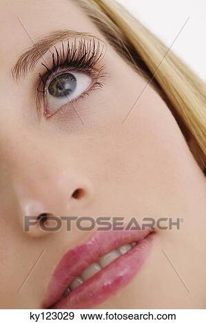 Portrait of a young woman looking up, close-up, indoors (studio) View Large Photo Image Stock Photo - Portrait of a young woman looking up, close-up, indoors (studio). Fotosearch