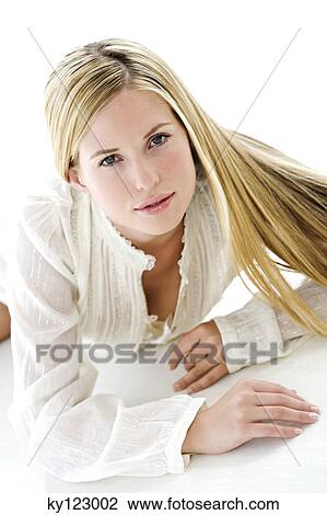 Portrait of a young woman lying, looking at the camera, indoors (studio) View Large Photo Image Stock Image - Portrait of a young woman lying, looking at the camera, indoors (studio). Fotosearch