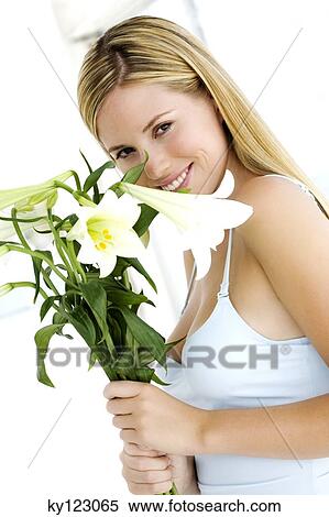 Portrait of a young woman smelling her wrist View Large Photo Image Stock Photography - Portrait of a young woman smelling her wrist. Fotosearch