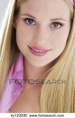Portrait of a young woman smiling, looking at the camera, indoors (studio) View Large Photo Image Stock Image - Portrait of a young woman smiling, looking at the camera, indoors (studio). Fotosearch