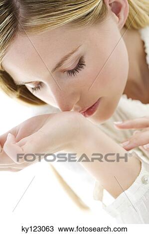 Portrait of a young woman using a lip balm View Large Photo Image Stock Image - Portrait of a young woman using a lip balm. Fotosearch