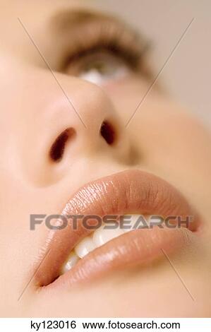 Woman looking up, close-up of her mouth, indoors(studio) View Large Photo Image Stock Photograph - Woman looking up, close-up of her mouth, indoors(studio). Fotosearch