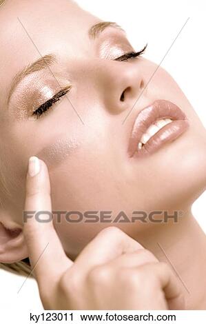 Woman putting make-up base on her cheek, shut eyes, indoors (studio) View Large Photo Image Stock Image - Woman putting make-up base on her cheek, shut eyes, indoors (studio). Fotosearch