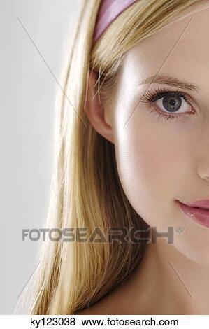Young Woman half face with make up, looking at the camera, close-up, indoors (studio) View Large Photo Image Stock Photo - Young Woman half face with make up, looking at the camera, close-up, indoors (studio). Fotosearch