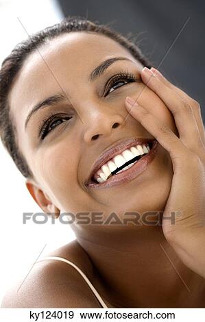 Portrait of a young smiling woman, hand on cheek View Large Photo Image Stock Photo - Portrait of a young smiling woman, hand on cheek. Fotosearch
