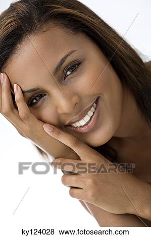 Portrait of a young smiling woman with hand on cheek View Large Photo Image Stock Photo - Portrait of a young smiling woman with hand on cheek. Fotosearch