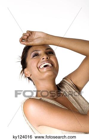 Stock Photograph - Portrait of a young smiling woman with hand on forehead. Fotosearch