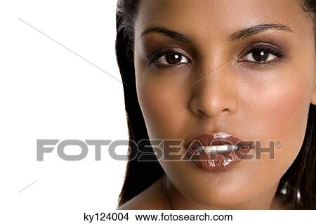 Portrait of a young woman looking at the camera View Large Photo Image Picture - Portrait of a young woman looking at the camera. Fotosearch