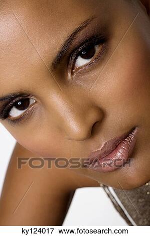 Portrait of a young woman looking at the camera View Large Photo Image Stock Photo - Portrait of a young woman looking at the camera. Fotosearch