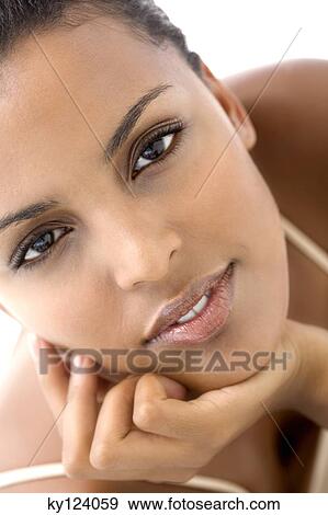 Portrait of a young woman looking at the camera View Large Photo Image Stock Photo - Portrait of a young woman looking at the camera. Fotosearch