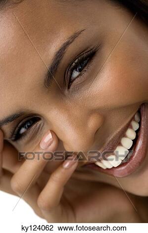 Portrait of a young woman smiling for the camera View Large Photo Image Stock Image - Portrait of a young woman smiling for the camera. Fotosearch