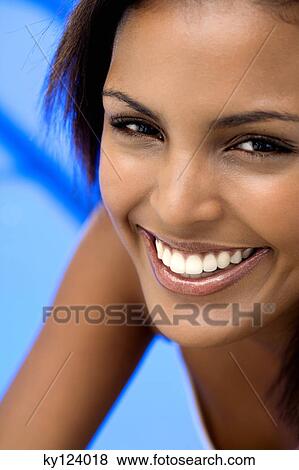 Stock Photo - Portrait of a young woman smiling for the camera. Fotosearch