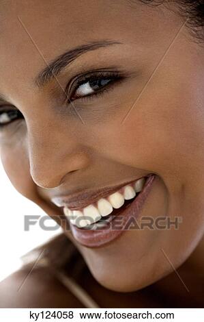 Portrait of a young woman smiling for the camera View Large Photo Image Stock Photo - Portrait of a young woman smiling for the camera. Fotosearch
