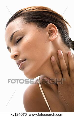 Portrait of a young woman with hand on her neck, eyes closed View Large Photo Image Stock Image - Portrait of a young woman with hand on her neck, eyes closed. Fotosearch