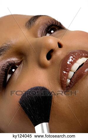 Young woman applying blush View Large Photo Image Stock Photography - Young woman applying blush. Fotosearch