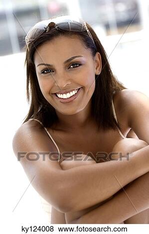Young woman smiling for the camera View Large Photo Image Stock Photo - Young woman smiling for the camera. Fotosearch
