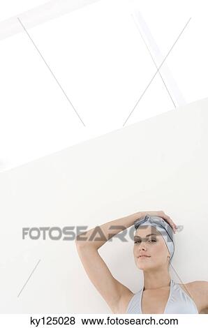 Portrait of a young woman with bikini, swimming cap and goggles, hand on head View Large Photo Image Stock Photo - Portrait of a young woman with bikini, swimming cap and goggles, hand on head. Fotosearch