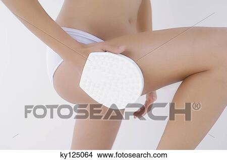 Woman using massage glove View Large Photo Image Picture - Woman using massage glove. Fotosearch