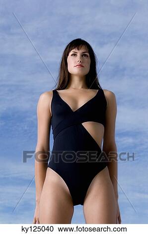 Stock Image - Young woman in black sexy swimming costume. Fotosearch