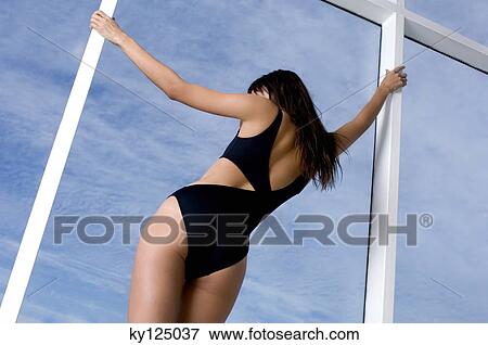 Young woman in black sexy swimming costume, rear view View Large Photo Image Stock Photo - Young woman in black sexy swimming costume, rear view. Fotosearch