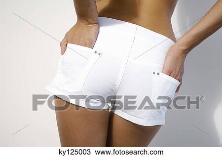 Young woman in shorts, hands in pocket, rear view View Large Photo Image Stock Image - Young woman in shorts, hands in pocket, rear view. Fotosearch