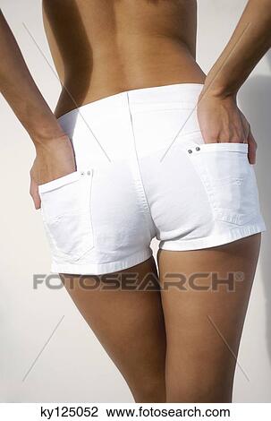 Young woman in shorts, hands in pocket, rear view View Large Photo Image Stock Image - Young woman in shorts, hands in pocket, rear view. Fotosearch