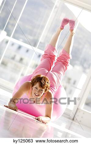 Young woman lying on big pink balloon View Large Photo Image Stock Image - Young woman lying on big pink balloon. Fotosearch