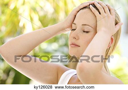Portrait of a young woman, eyes shut, hands on her head, outdoors View Large Photo Image Stock Photo - Portrait of a young woman, eyes shut, hands on her head, outdoors. Fotosearch