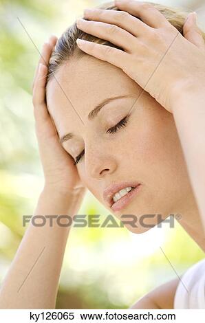 Portrait of a young woman, eyes shut, hands on her head, outdoors View Large Photo Image Stock Photography - Portrait of a young woman, eyes shut, hands on her head, outdoors. Fotosearch