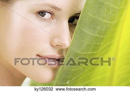 Portrait of a young woman looking at the camera, banana leaf, outdoors View Large Photo Image Stock Image - Portrait of a young woman looking at the camera, banana leaf, outdoors. Fotosearch