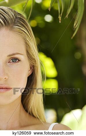 Portrait of half of a young woman's face, looking at the camera, close-up, outdoors View Large Photo Image Stock Photo - Portrait of half of a young woman's face, looking at the camera, close-up, outdoors. Fotosearch