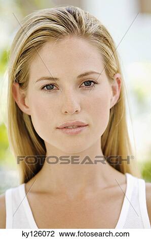 Portrait of young woman looking at the camera, outdoors View Large Photo Image Stock Image - Portrait of young woman looking at the camera, outdoors. Fotosearch