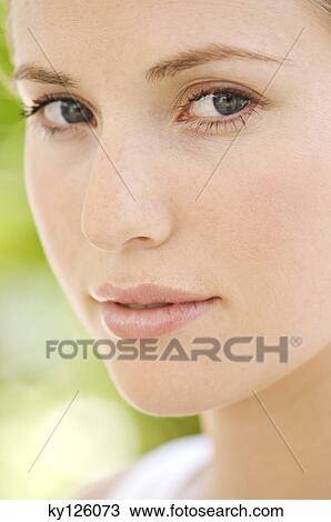 Portrait of young woman looking at the camera, outdoors View Large Photo Image Stock Image - Portrait of young woman looking at the camera, outdoors. Fotosearch